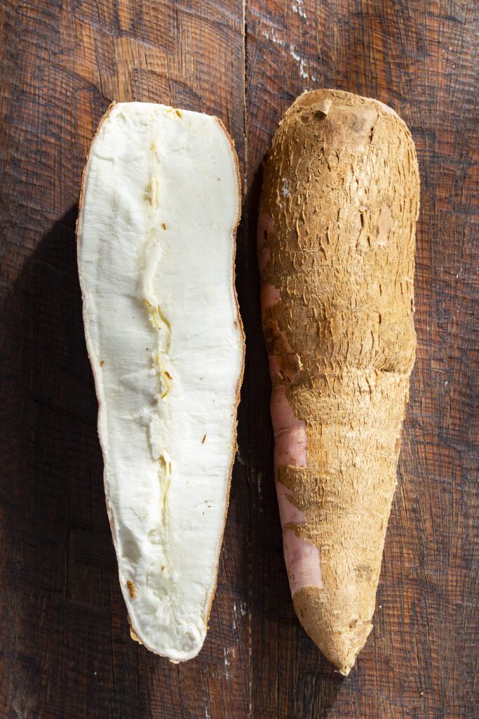 Fresh white sweet potatoes on a rustic wooden surface