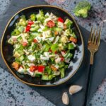 Fresh broccoli cauliflower salad recipe with cheddar cheese, red onion, and a creamy dressing.