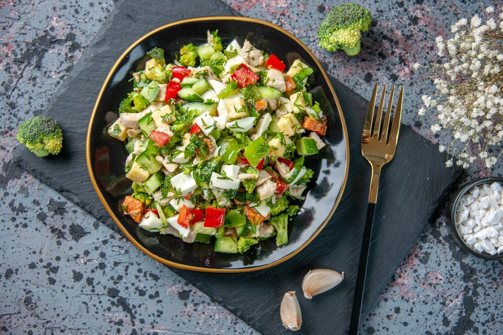 Fresh broccoli cauliflower salad recipe with cheddar cheese, red onion, and a creamy dressing.